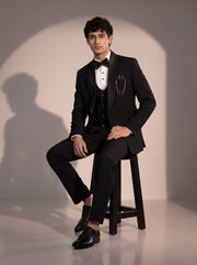 Black crystal trim tuxedo suit for men - seated pose