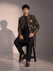 Black peacock embroidered silk indowestern for men - seated pose