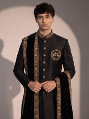 Close-up of black indowestern gold elephant crest, embroidered collar and velvet stole border