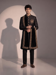 Black silk indowestern for men with velvet stole - three-quarter view showing gold crest