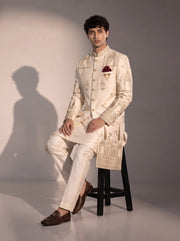 Cream Mughal embroidered silk indowestern for men - seated pose