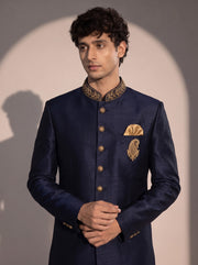 Dark navy indowestern close-up showing gold embroidered collar, gold buttons and brooch