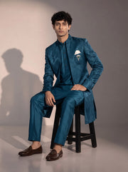 Teal blue jacquard silk indowestern for men - seated pose